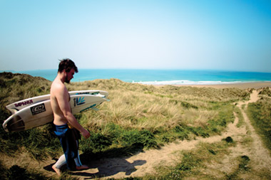 Surfer on beach footpath Image